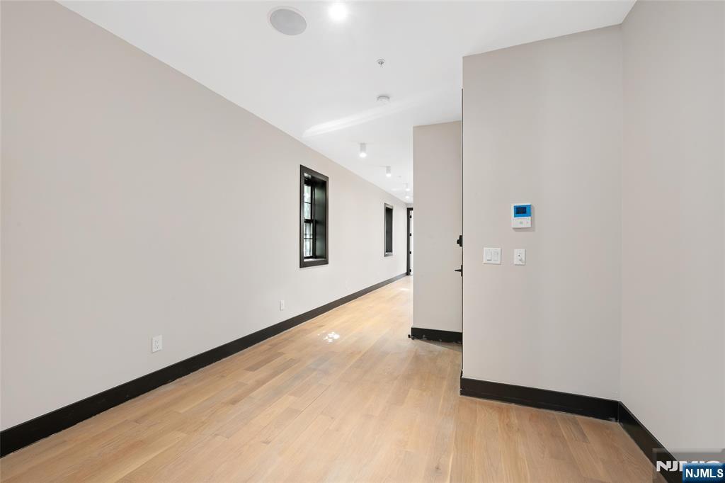 208 15th Street Jersey City, NJ 07310 - Photo 34 of 46 a view of a hallway with wooden floor