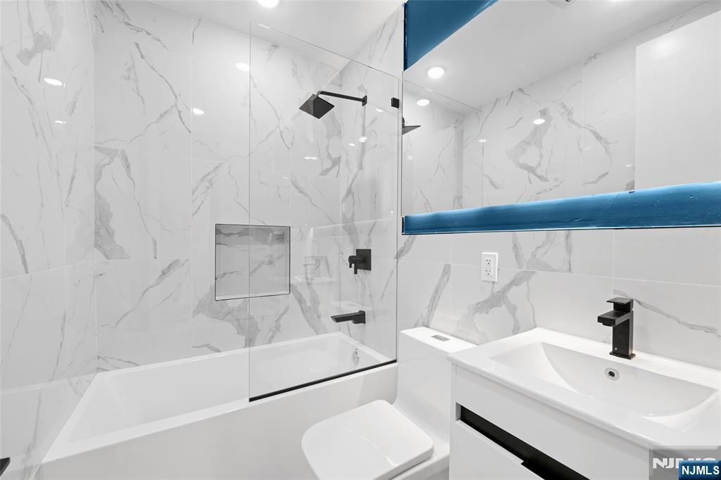 208 15th Street Jersey City, NJ 07310 - Photo 42 of 46 a bathroom with a sink a toilet and a bathtub