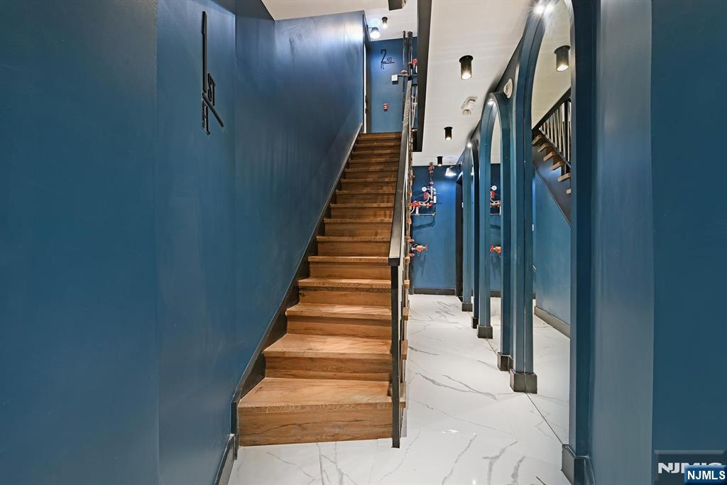 208 15th Street Jersey City, NJ 07310 - Photo 46 of 46 a view of staircase with lots of frames on wall and windows