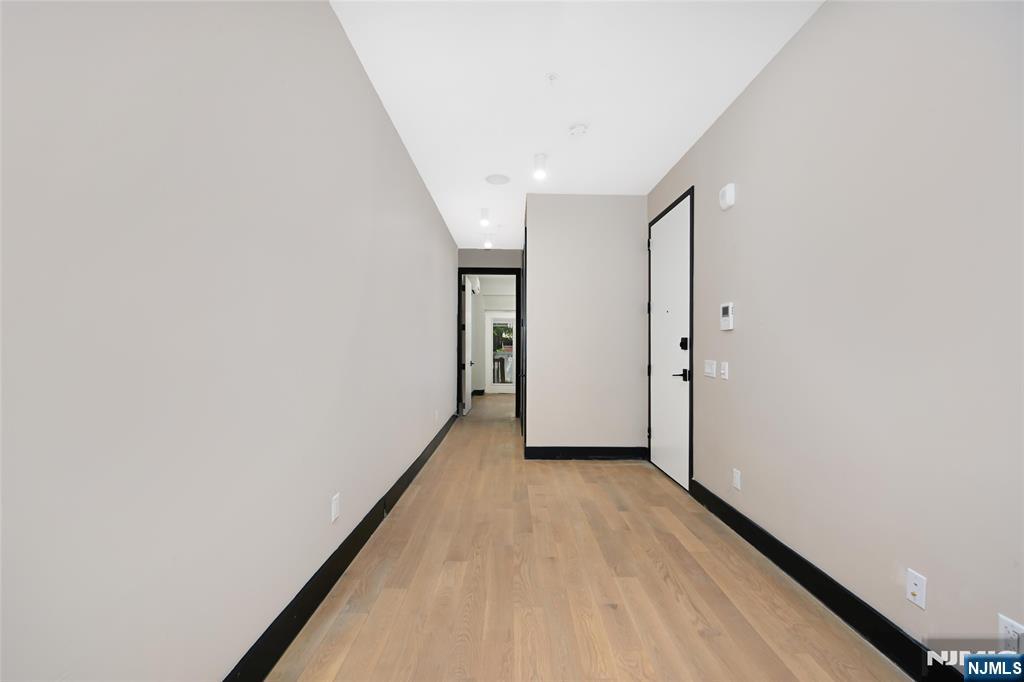208 15th Street Jersey City, NJ 07310 - Photo 5 of 46 a view of hallway with wooden floor