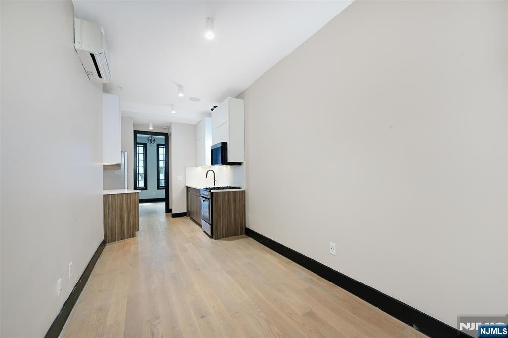 208 15th Street Jersey City, NJ 07310 - Photo 8 of 46 a view of a kitchen with a sink and dishwasher a refrigerator with wooden floor