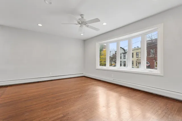 wooden floor in an empty room with a window