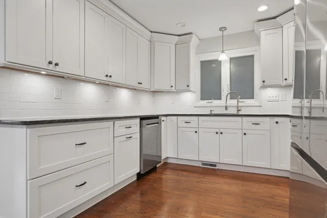 a kitchen with white cabinets and white appliances