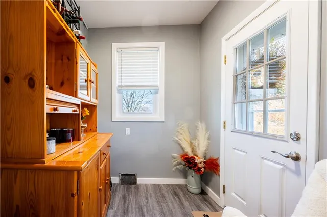 a view of a room with wooden floor and windows