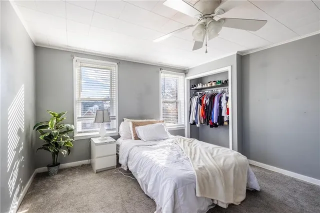 a bedroom with a bed and a potted plant