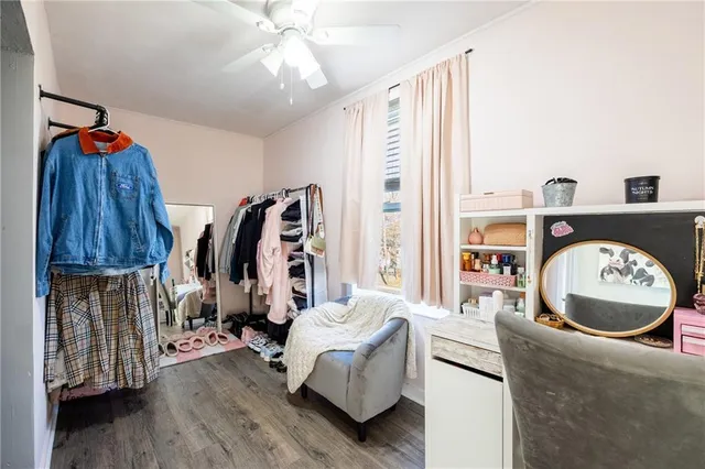 a living room with furniture and a painting on the wall