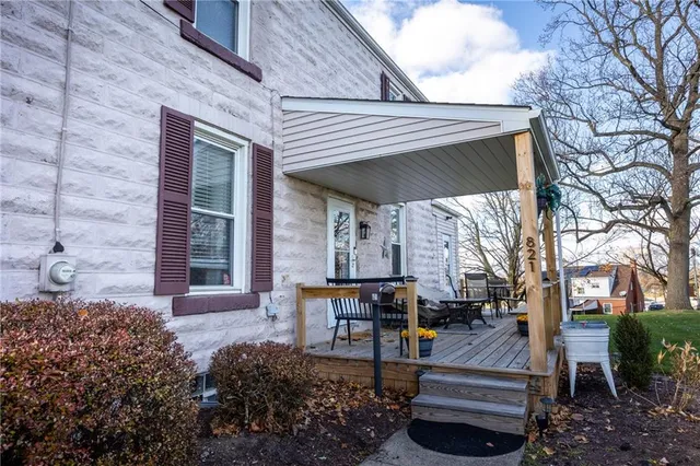 a front view of a house with outdoor seating
