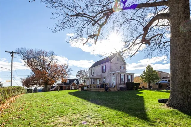 a view of house with yard