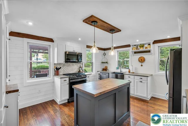 a bedroom with a bed and a mirror on the dresser