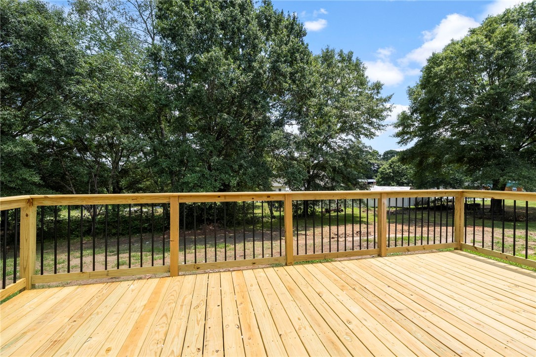 418 Old River Road Pelzer, SC 29669 - Photo 24 of 29 An inviting deck offers a serene overlook to a tree-lined yard.