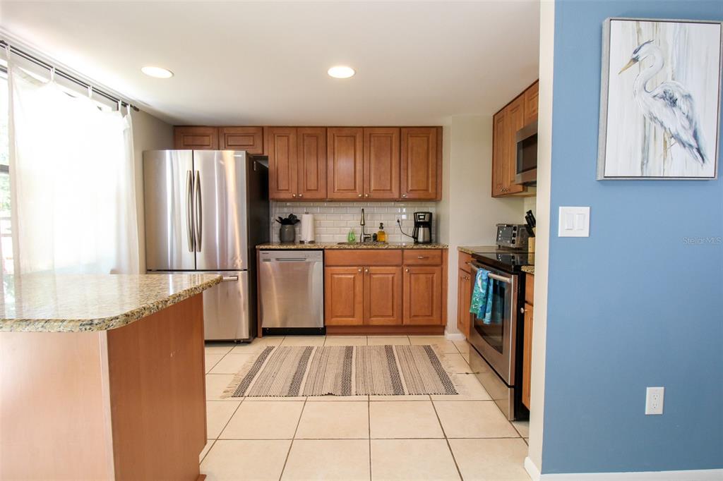 1116 Royal Road Venice, FL 34293 - Photo 13 of 26 a kitchen with stainless steel appliances granite countertop a refrigerator and a sink