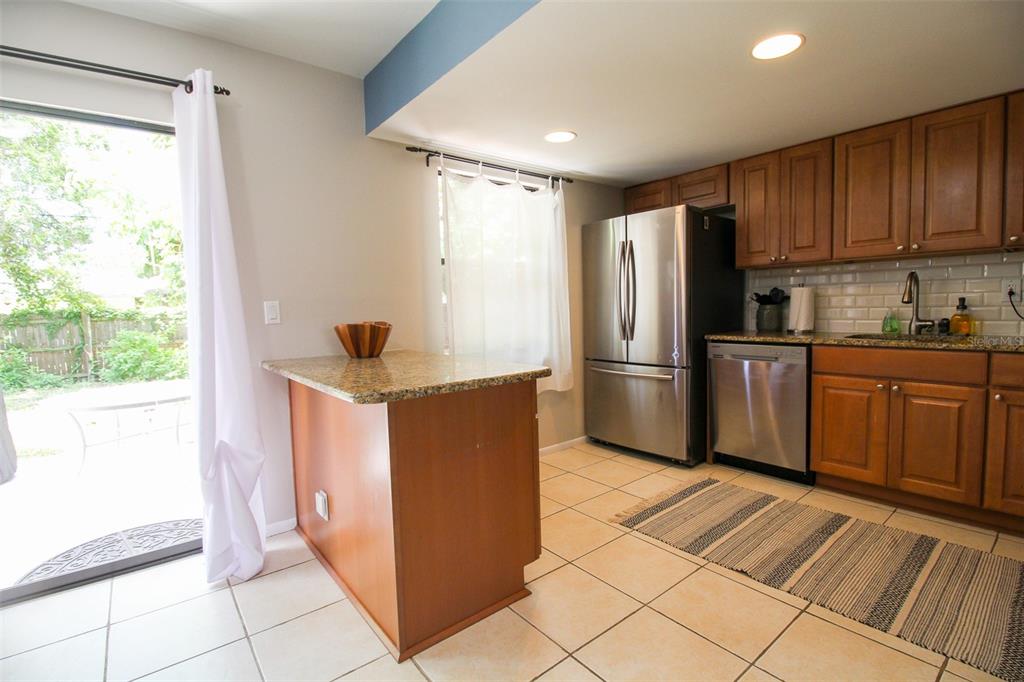 1116 Royal Road Venice, FL 34293 - Photo 14 of 26 a kitchen with stainless steel appliances granite countertop a refrigerator and a sink