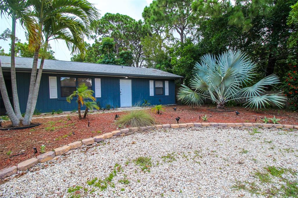 1116 Royal Road Venice, FL 34293 - Photo 2 of 26 a view of a backyard with a large tree