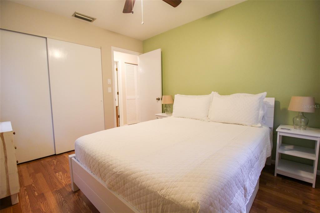 1116 Royal Road Venice, FL 34293 - Photo 23 of 26 a large bed sitting in a bedroom next to a bathroom