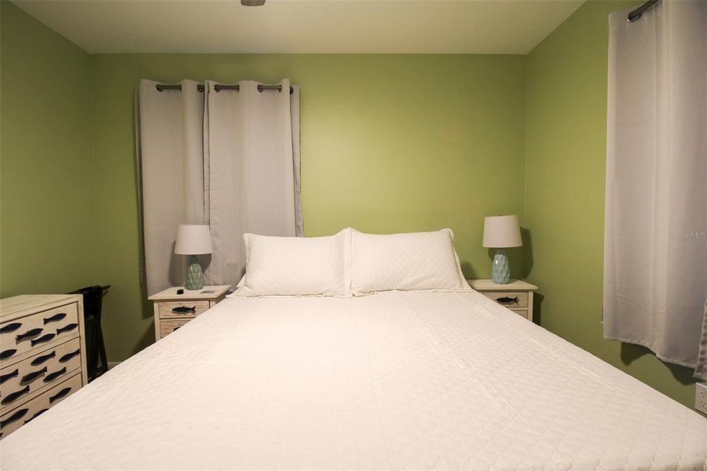 1116 Royal Road Venice, FL 34293 - Photo 24 of 26 a large bed in a bedroom next to a window
