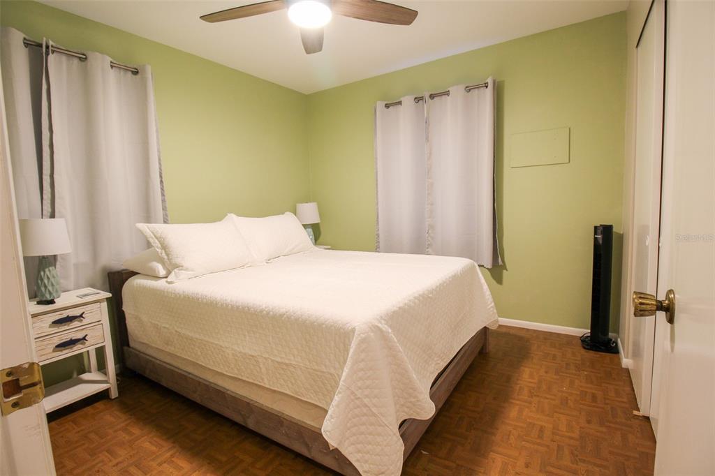 1116 Royal Road Venice, FL 34293 - Photo 26 of 26 a bedroom with a bed and a chandelier