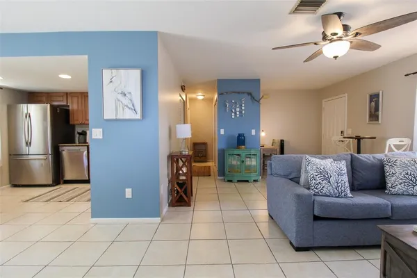 a living room with furniture and kitchen view