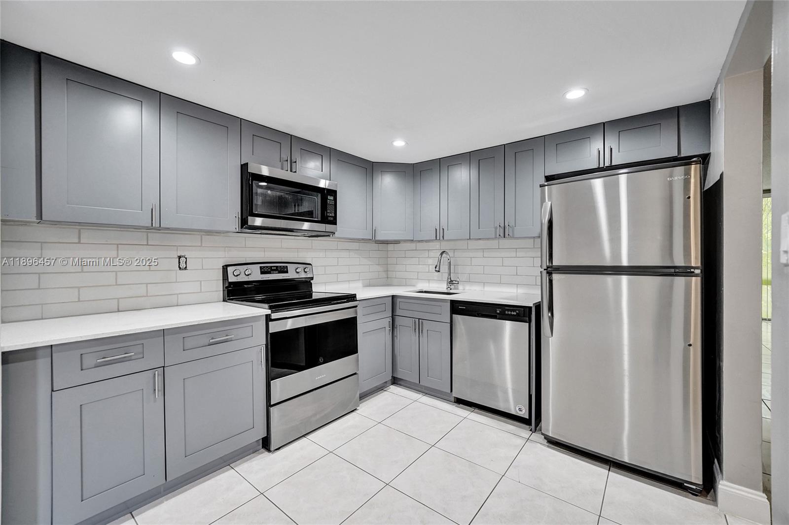 a kitchen with a refrigerator sink and microwave