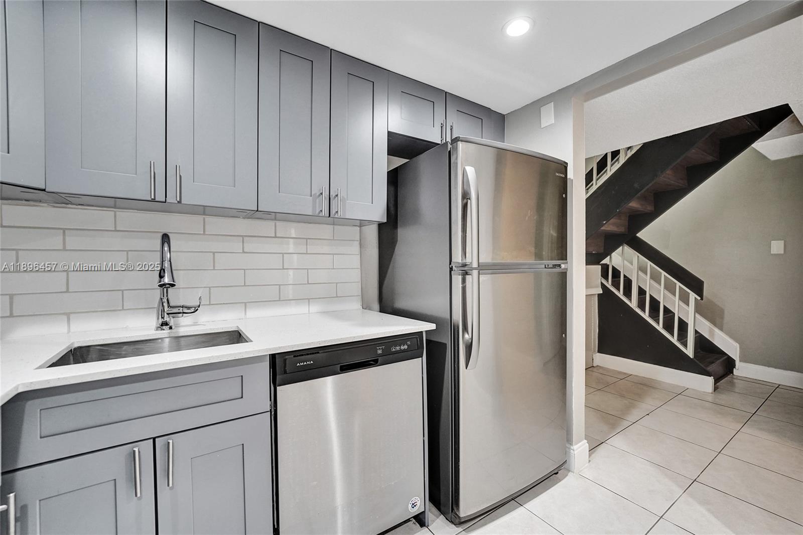8401 West Sample Road, Unit 20 Coral Springs, FL 33065 - Photo 15 of 61 a kitchen with stainless steel appliances a refrigerator and a sink