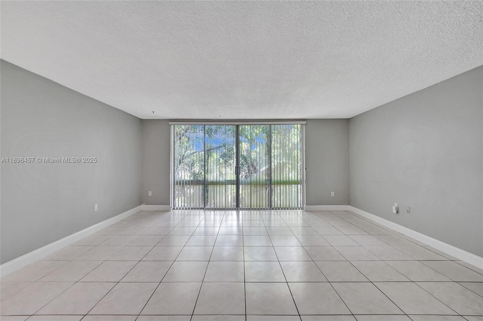 8401 West Sample Road, Unit 20 Coral Springs, FL 33065 - Photo 20 of 61 a view of an empty room with a window