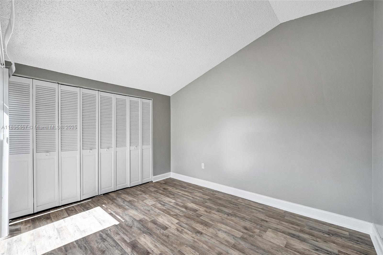 8401 West Sample Road, Unit 20 Coral Springs, FL 33065 - Photo 28 of 61 a view of an empty room with wooden floor