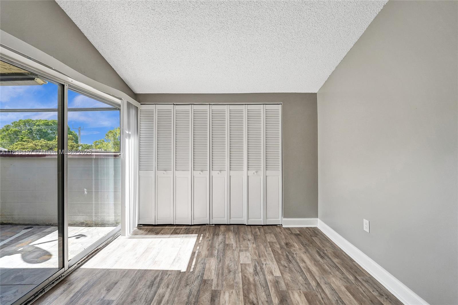 8401 West Sample Road, Unit 20 Coral Springs, FL 33065 - Photo 29 of 61 a view of an empty room with wooden floor