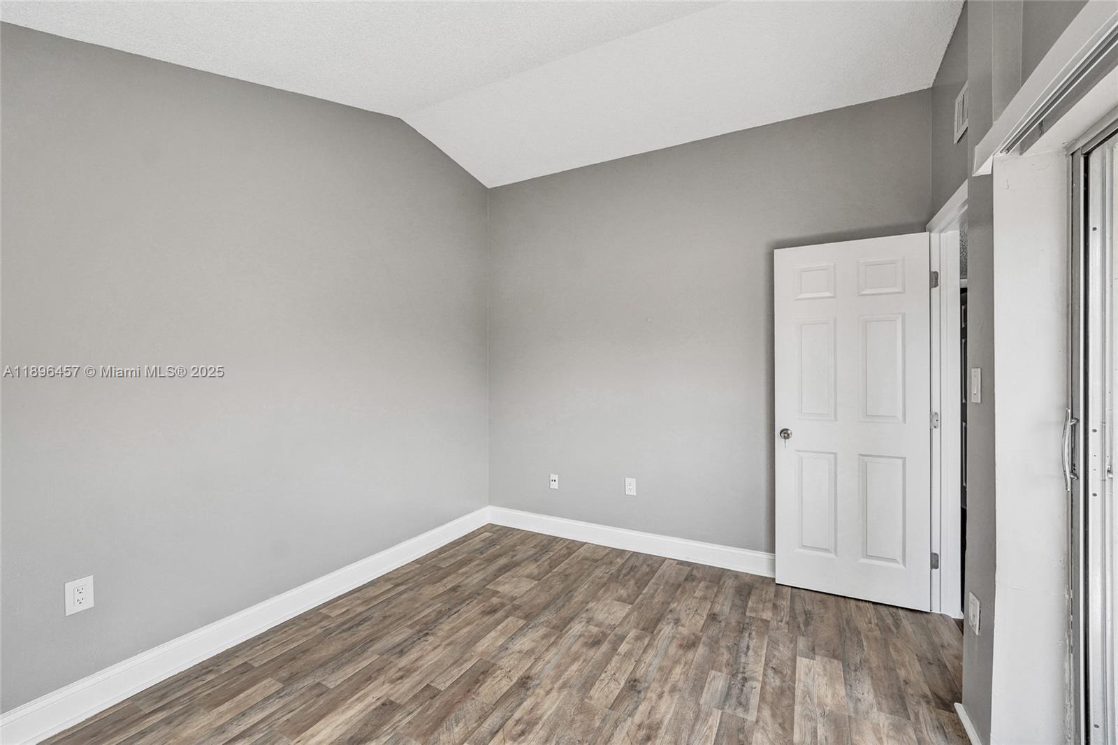 8401 West Sample Road, Unit 20 Coral Springs, FL 33065 - Photo 32 of 61 a view of an empty room with wooden floor and closet
