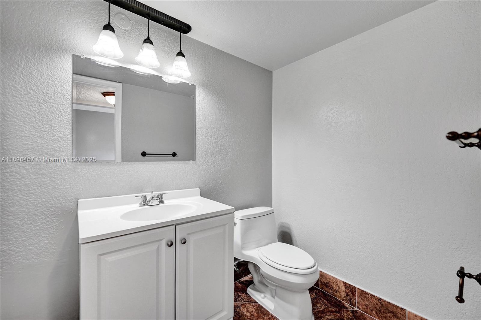 8401 West Sample Road, Unit 20 Coral Springs, FL 33065 - Photo 4 of 61 a bathroom with a sink a toilet and mirror