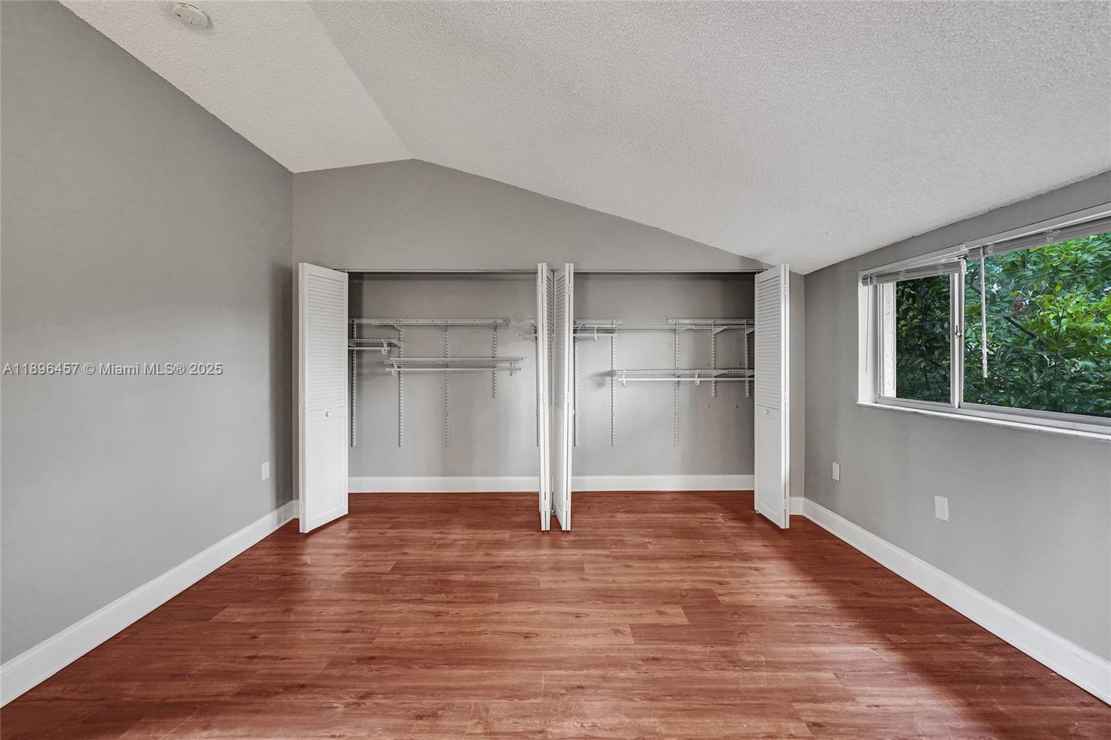 8401 West Sample Road, Unit 20 Coral Springs, FL 33065 - Photo 46 of 61 a view of empty room with wooden floor and window