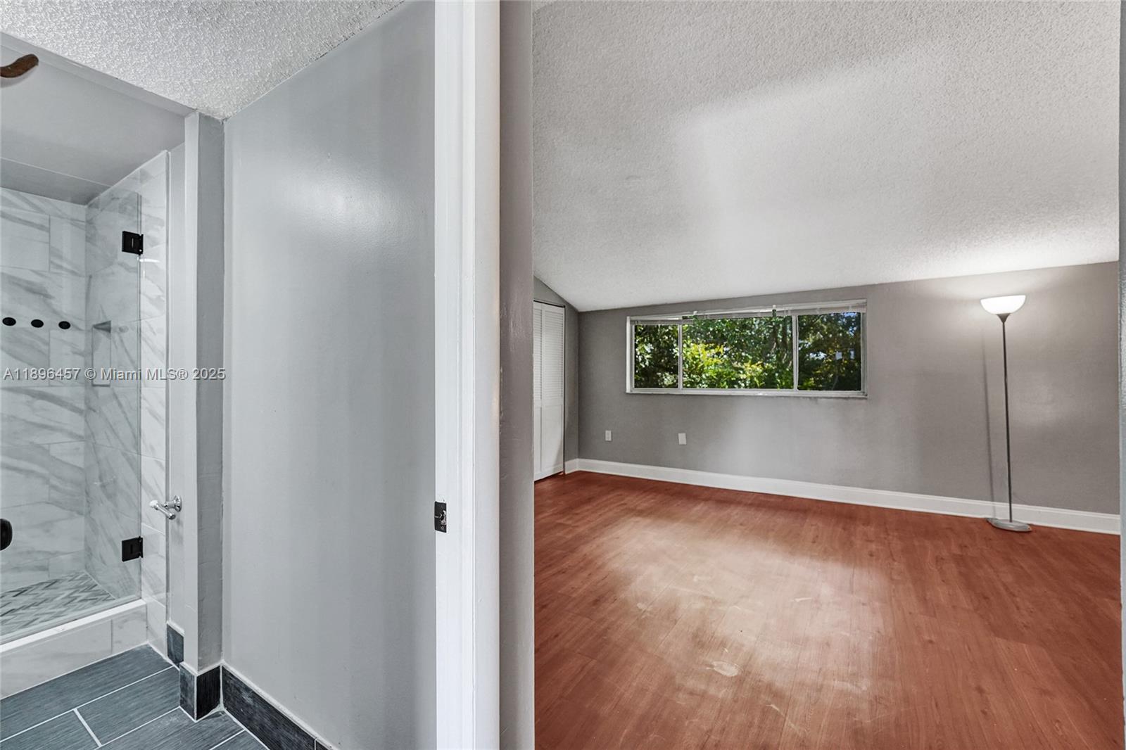 8401 West Sample Road, Unit 20 Coral Springs, FL 33065 - Photo 48 of 61 a view of a hallway with wooden floor and a bathroom