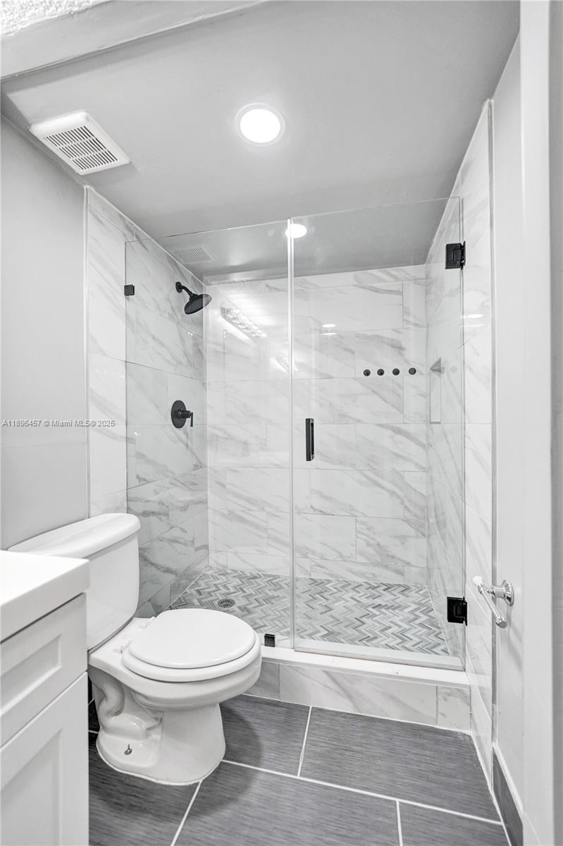8401 West Sample Road, Unit 20 Coral Springs, FL 33065 - Photo 49 of 61 a bathroom with a toilet and a shower