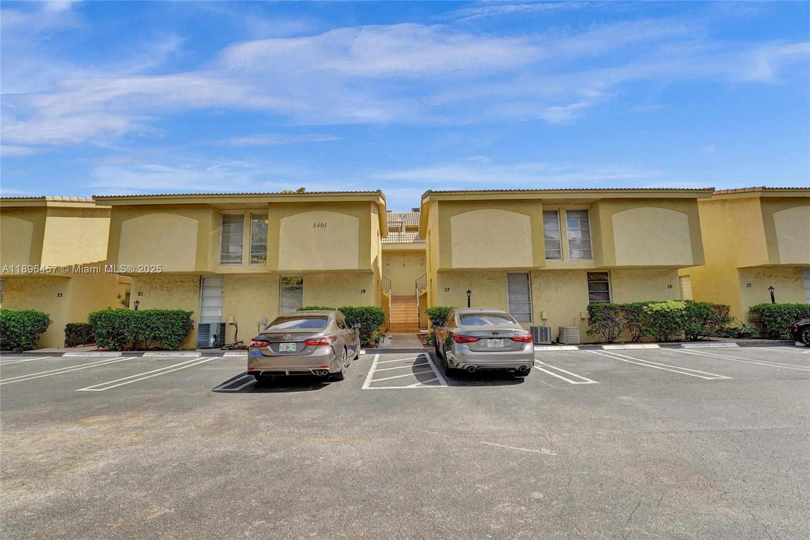 8401 West Sample Road, Unit 20 Coral Springs, FL 33065 - Photo 55 of 61 a car parked in front of a building