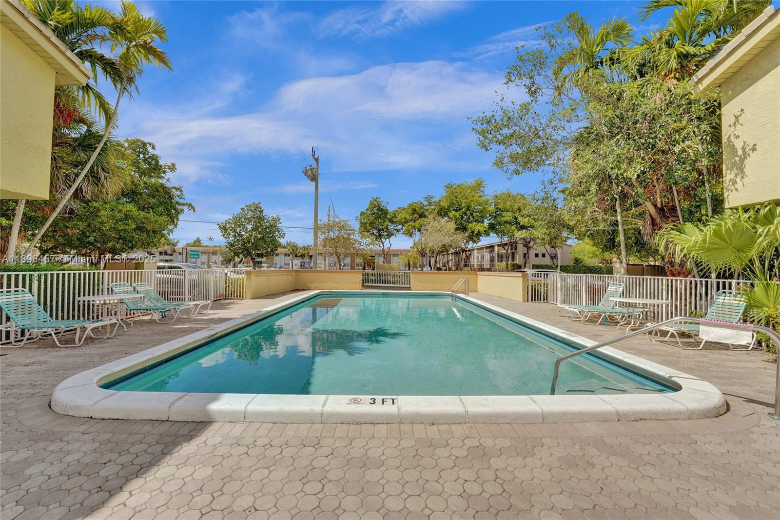 8401 West Sample Road, Unit 20 Coral Springs, FL 33065 - Photo 58 of 61 a view of a swimming pool with a lounge chairs