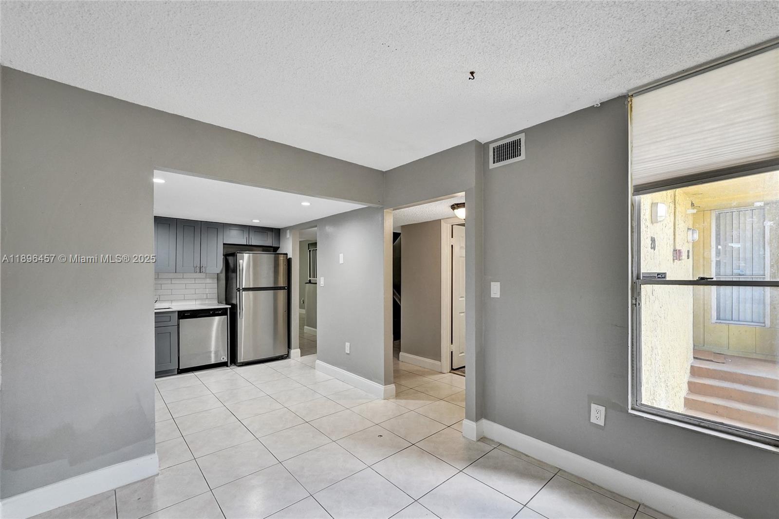 8401 West Sample Road, Unit 20 Coral Springs, FL 33065 - Photo 8 of 61 a view of a kitchen with a sink and a window