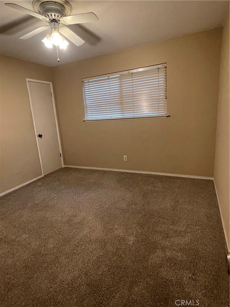 658 David Court Merced, CA 95340 - Photo 11 of 18 an empty room with a ceiling fan and window