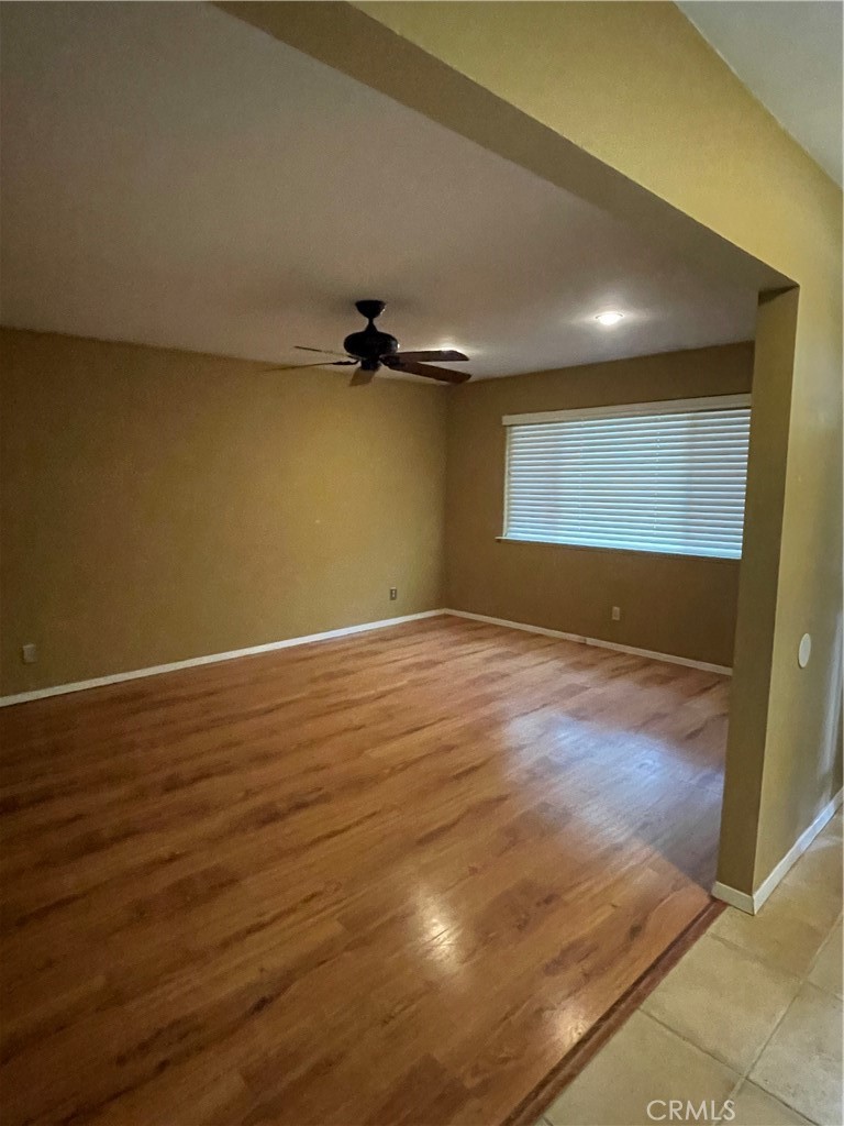 658 David Court Merced, CA 95340 - Photo 4 of 18 an empty room with wooden floor and windows