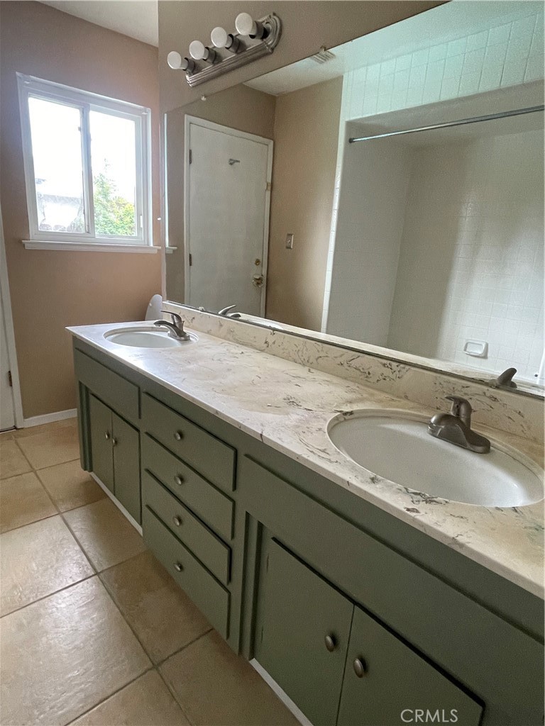 658 David Court Merced, CA 95340 - Photo 7 of 18 a bathroom with a granite countertop sink and a mirror