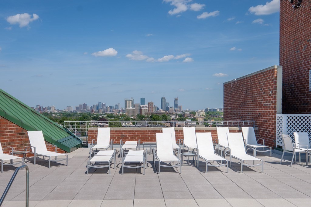 15 North Beacon Street, Unit 217 Boston, MA 02134 - Photo 15 of 21 a view of a terrace with furniture and city view