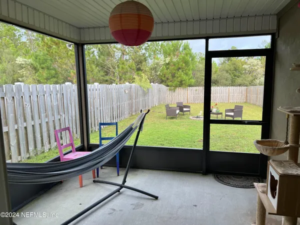 a living room with large windows and furniture