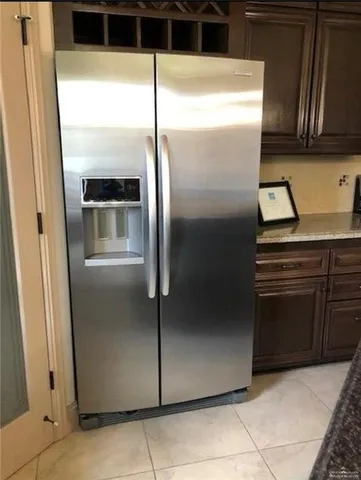 a kitchen with a refrigerator and a sink