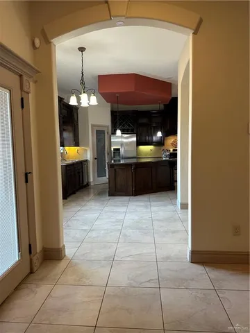 a kitchen view with granite countertop a rug a stove and a shower