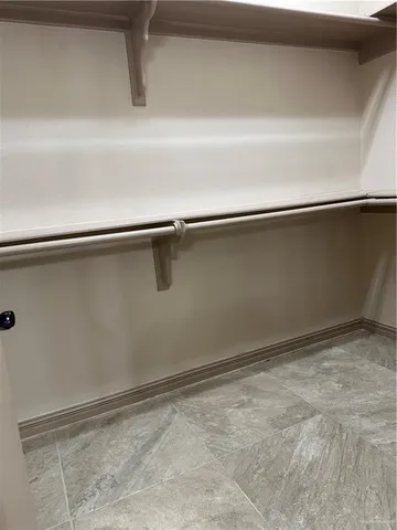 a bathroom with a granite countertop sink a mirror and a shower