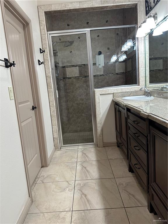 2720 Fairmont Avenue McAllen, TX 78504 - Photo 27 of 35 a bathroom with a granite countertop sink a mirror and a shower