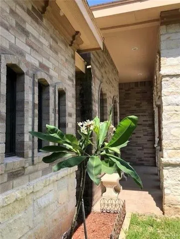 a glass vase with white and yellow flowers
