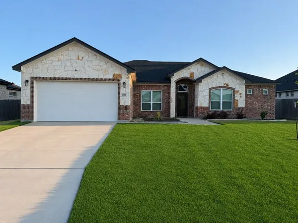 a front view of house with yard and green space