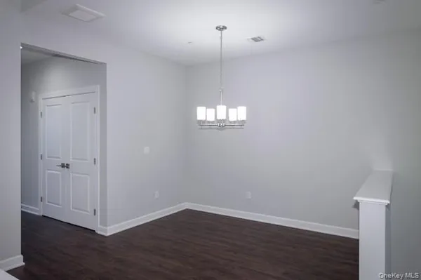 a view of a room with wooden floor and window