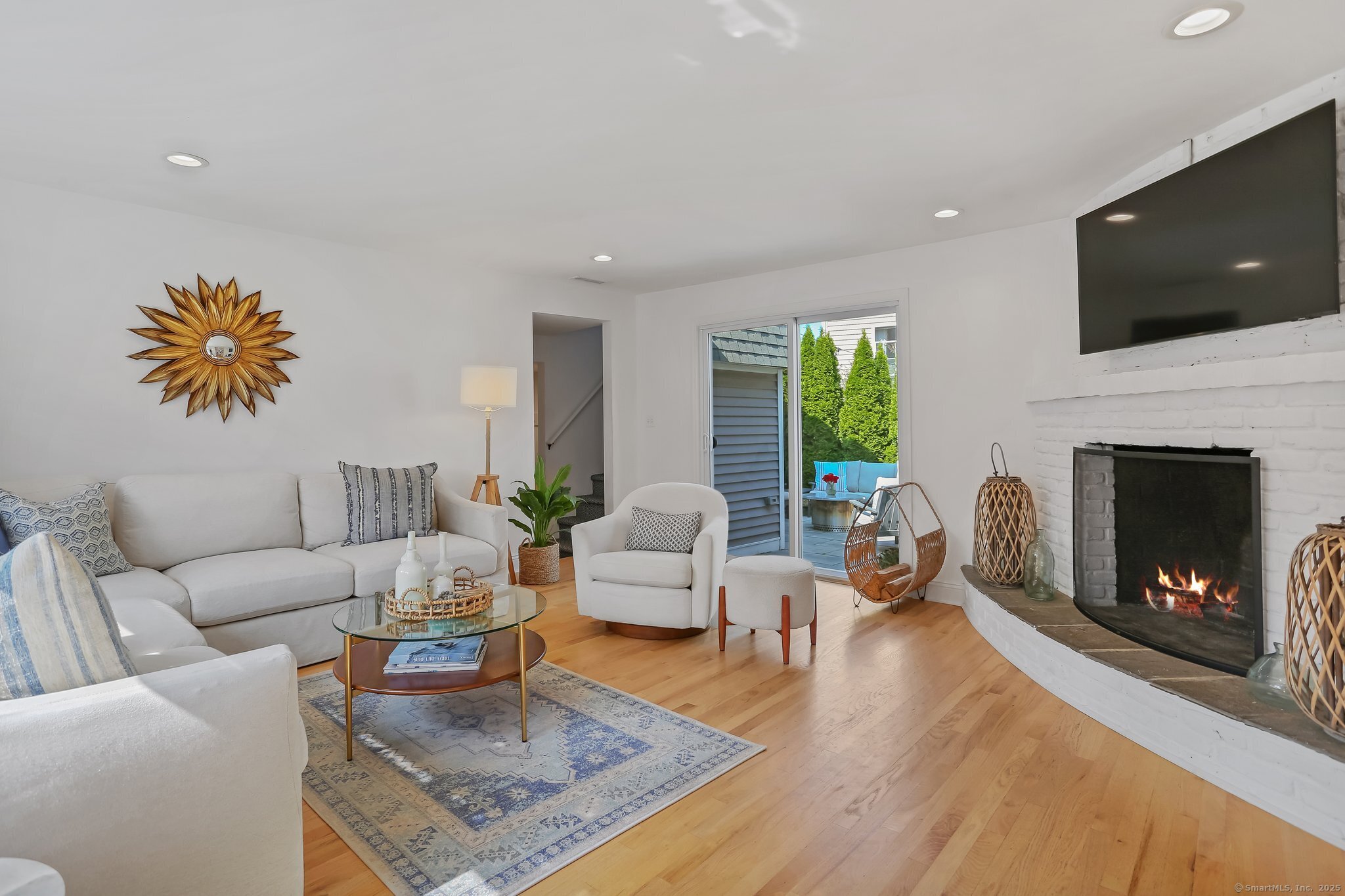 550 Reef Road Fairfield, CT 06824 - Photo 1 of 1 a living room with furniture fireplace and a flat screen tv