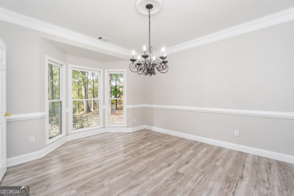 6710 Timber Cove Pointe Cumming, GA 30041 - Photo 11 of 51 wooden floor in an empty room with a window