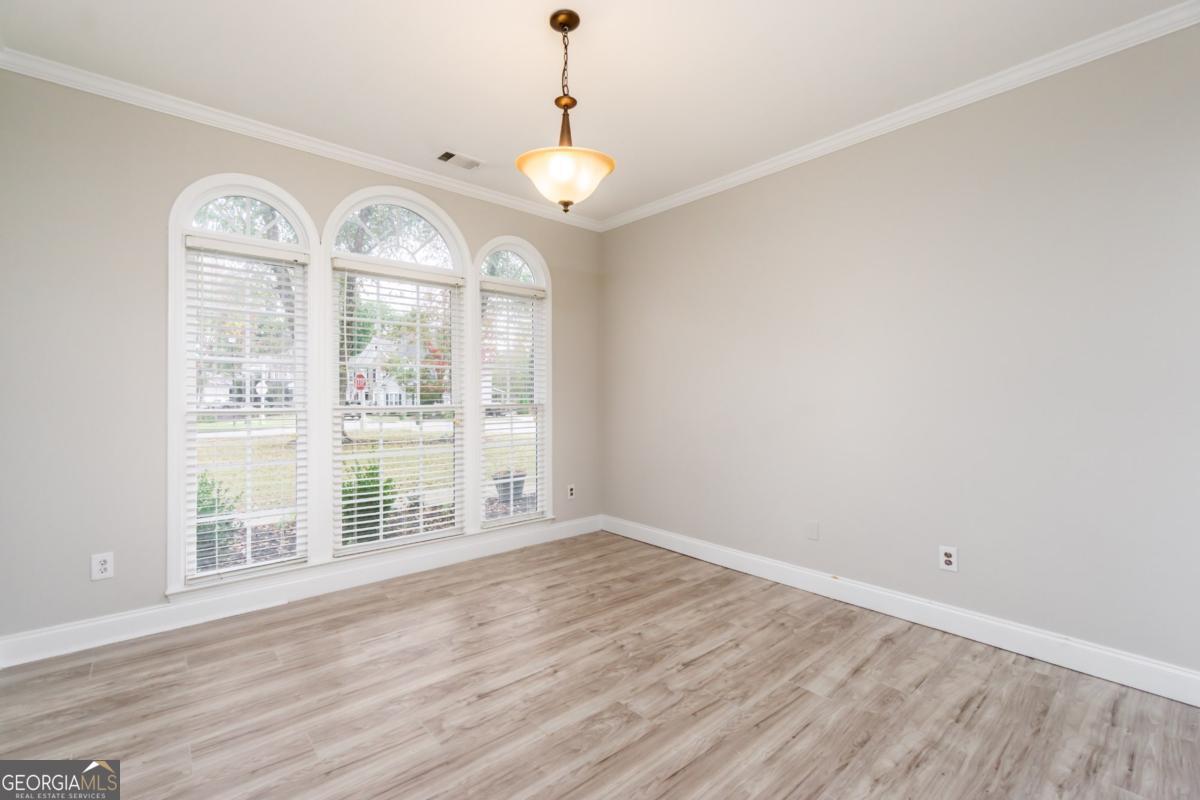 6710 Timber Cove Pointe Cumming, GA 30041 - Photo 14 of 51 an empty room with wooden floor and windows