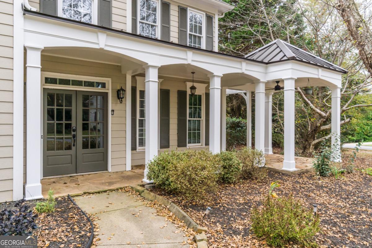 6710 Timber Cove Pointe Cumming, GA 30041 - Photo 2 of 51 front view of a brick house with a large window